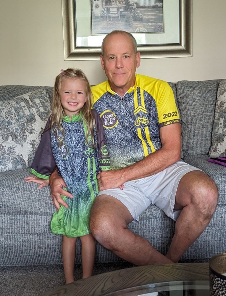 Rider with his granddaughter Ella, both wearing Closer to Free Ride jerseys